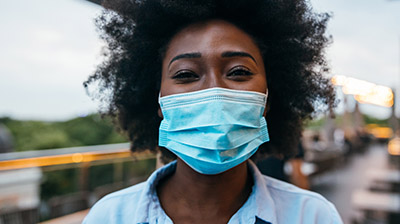 A woman wearing a blue face mask 
