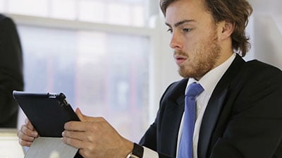 Man in business attire using a smart tablet 