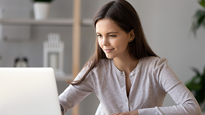 A woman sitting while using a laptop 